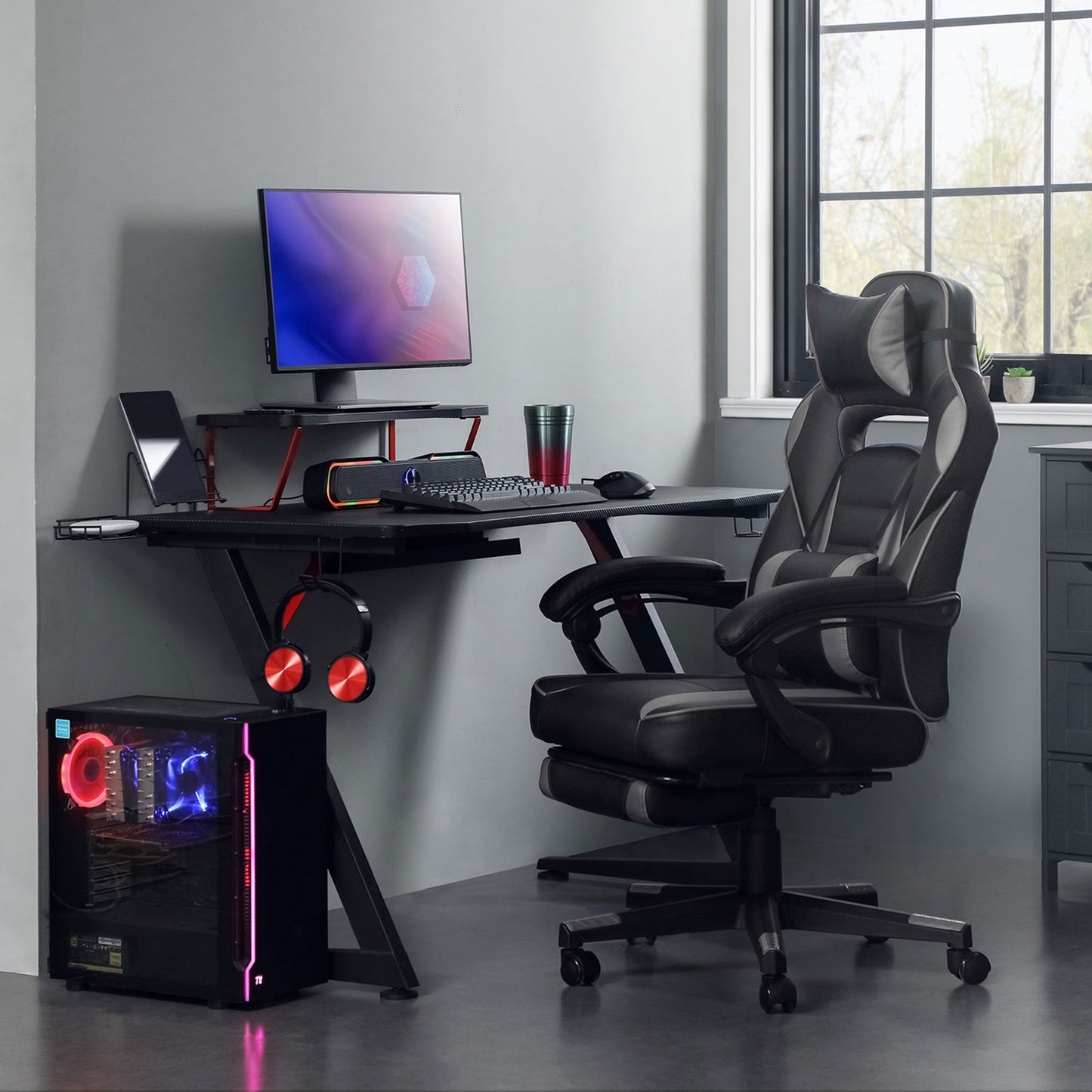 Height-adjustable gaming chair with footrest